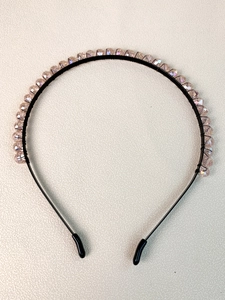 Detailed view of handmade crystal crown headband with purple faceted beads and black frame
