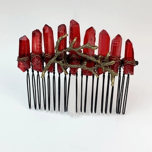 Detailed view of handmade gothic hair comb with red crystals and gold alloy branches