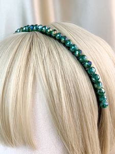 Close-up of deep green faceted crystal beads on a delicate bridal crown headband