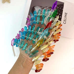Detailed macro view of handmade rainbow crystal crown with silver moon and metal wire wrapping