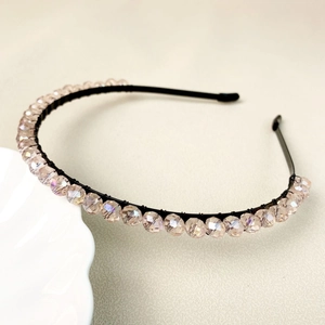 Elegant beaded headband with champagne crystals on a black frame for bridal hair