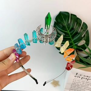 Detailed macro view of handmade rainbow crystal crown with silver wire and moon pendant