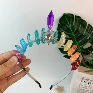 Detail of colorful crystal crown with moon ornament and wire-wrapped rainbow stones
