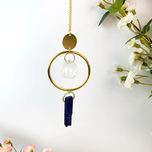 Detailed view of suncatcher featuring blue natural stone and crystal ball pendant