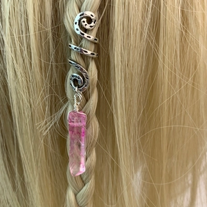 Detail of pink crystal pendant hair rings on blonde braid with vintage silver spiral
