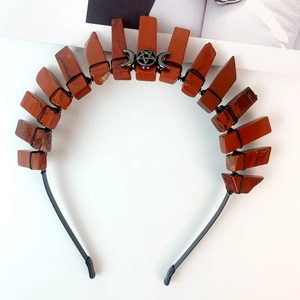 Detailed view of handmade black moon headband with red jasper crystals and pentagram