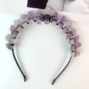 Macro shot of Gothic black crescent moon crown with raw purple amethyst crystals