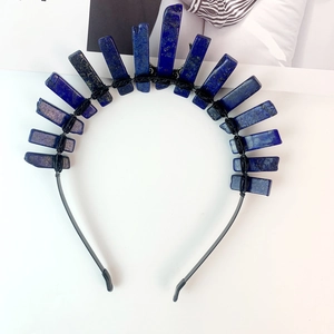 Macro shot of blue quartz crystals hand-wrapped with black wire on a moon crown headband