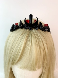 Detailed close-up of Gothic moon crown with black crystals and red spinel on headband