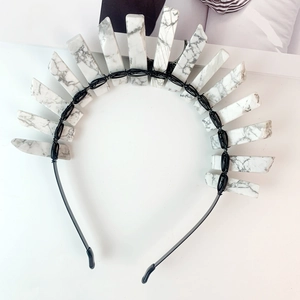 Detail of handcrafted bohemian crown with white marble stones on a black headband