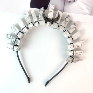 Macro view of handmade black moon headband with marbled stone and wire wrapping