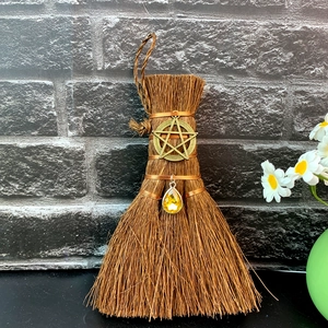Detail of wicca mini broom car charm with bronze pentagram and yellow crystal teardrop