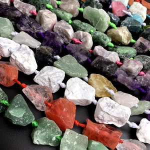Macro view of colorful raw crystal stones including amethyst and agate with woven ropes