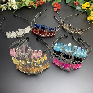 Flat lay of handmade moon headbands with multi-color crystals and metallic details