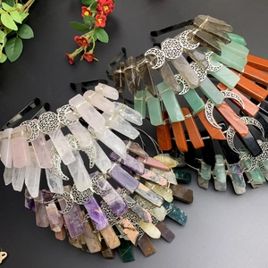 Detail view of handmade crystal crown headbands with triple moon symbol and raw gemstones