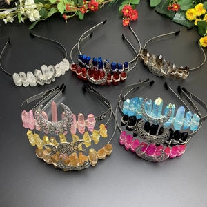 Detail view of handmade moon tiaras with colorful crystal stones and wire-wrapped metal finish