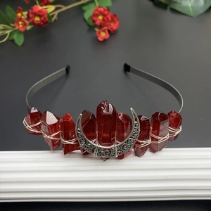 Detail of red crystal quartz crown with silver moon and handmade wire wrap design