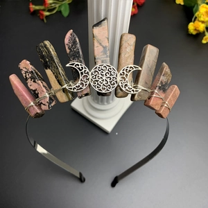 Detail view of handmade triple moon crown with natural pink crystal and black wire