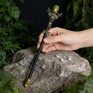 Natural crystal magic wand with gold bee and moon phase symbols for ritual decor