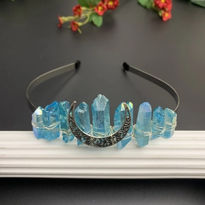 Detail of blue crystal crown with silver crescent moon accent and hand-wrapped wire work