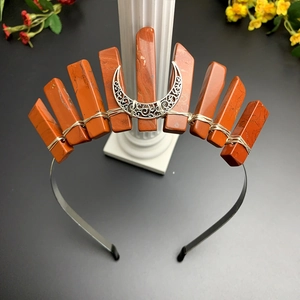 Macro detail of red jasper stones and silver moon on a handmade crystal crown headband