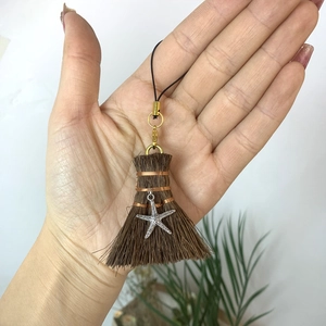 Handmade brown fiber broom pendant with silver star charm and golden lobster clasp