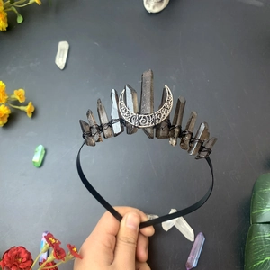 Detailed view of handmade gothic crown featuring black crystal points and silver moon crescent