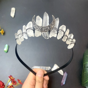 Detail of handmade bohemian crown with natural white crystal clusters and crescent moon symbol