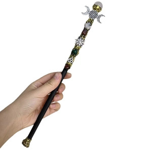Natural crystal magic wand with triple goddess and sun symbols on a white background