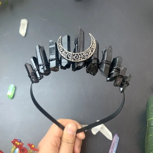 Close-up of gothic crystal crown featuring black stones and silver moon detailing