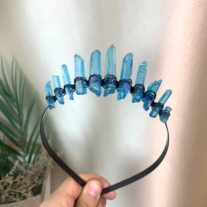 Close-up of handmade blue crystal crown with black wire wrapping on metal headband