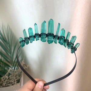 Detail of green raw crystal crown featuring black wire wrapping on a slim metal headband