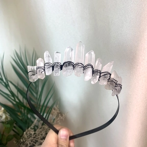 Detail of clear quartz crystal crown with black wire wrap on a handmade headband