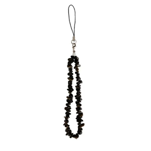 Macro shot of natural irregular black crystal stones on a durable phone charm strap