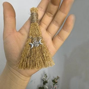 Handmade straw broom featuring a silver triple moon goddess pentagram charm decoration