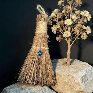 Handcrafted decorative mini broom with blue crystal teardrop and natural wood texture