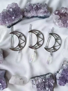 Three-piece silver moon hair clips with natural white crystal pendants on white silk