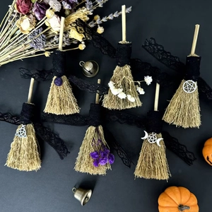 Handmade mini witch brooms with lace flowers and mystical symbols on black background