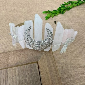 Macro detail of handmade crystal crown featuring silver crescent moon and dragonflies