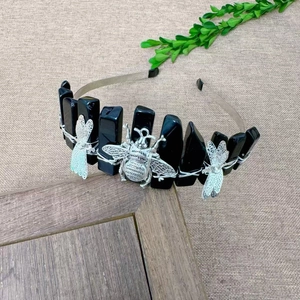 Detailed view of handmade black crystal headband with dragonfly and bee metal charms