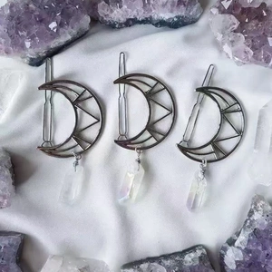 Three silver crescent moon hair clips with natural iridescent quartz crystals on silk