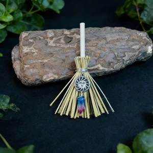 Handmade witch broom pendant with silver sun charm and crystal point on bark