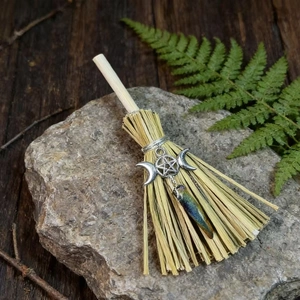Mini witch broom charm with crystal and silver pentagram symbol on natural stone