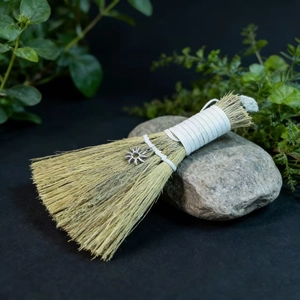 Miniature handmade altar broom with silver sun charm and natural plant fiber detail