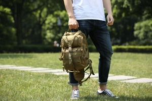Close-up of khaki tactical chest bag with MOLLE webbing system and durable fabric