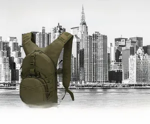 Detail view of military green tactical backpack showing the MOLLE webbing and elastic cord