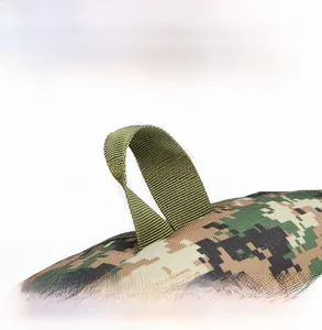Detail shot of the durable green nylon top handle and digital camo fabric of the backpack