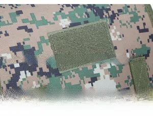 Detailed close-up of tactical backpack with digital camo pattern and hook-and-loop patch area