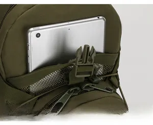 Front mesh pocket of green tactical backpack holding a tablet with secure buckle