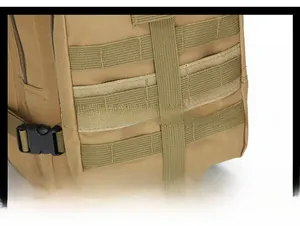 Detailed view of tactical MOLLE system with velcro panels on brown outdoor backpack